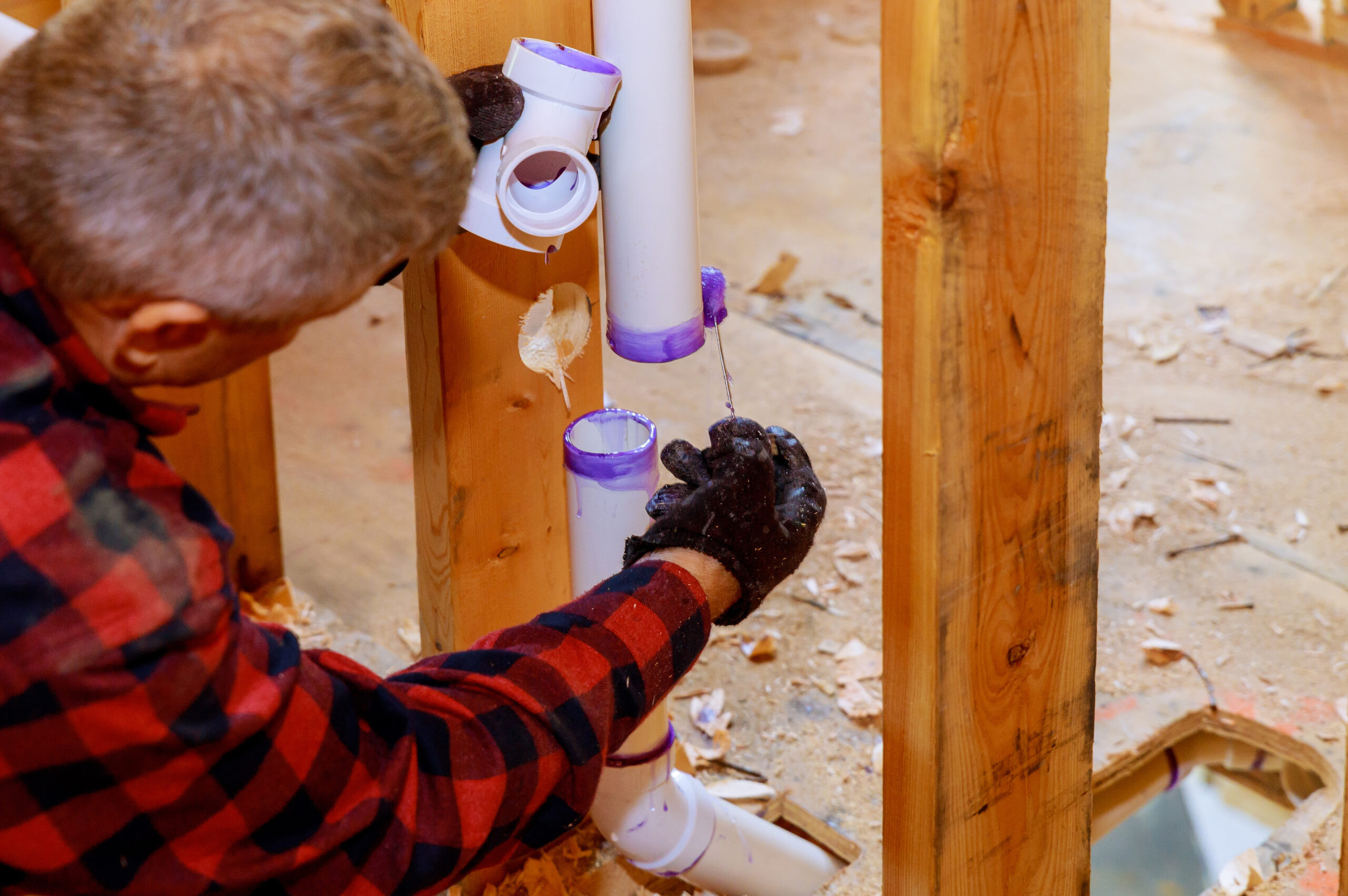 Plumber assembling and glue pvc drain pipes
